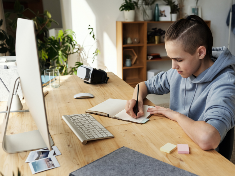 Teenager Junge Notizheft Schreibtisch Bildschirm